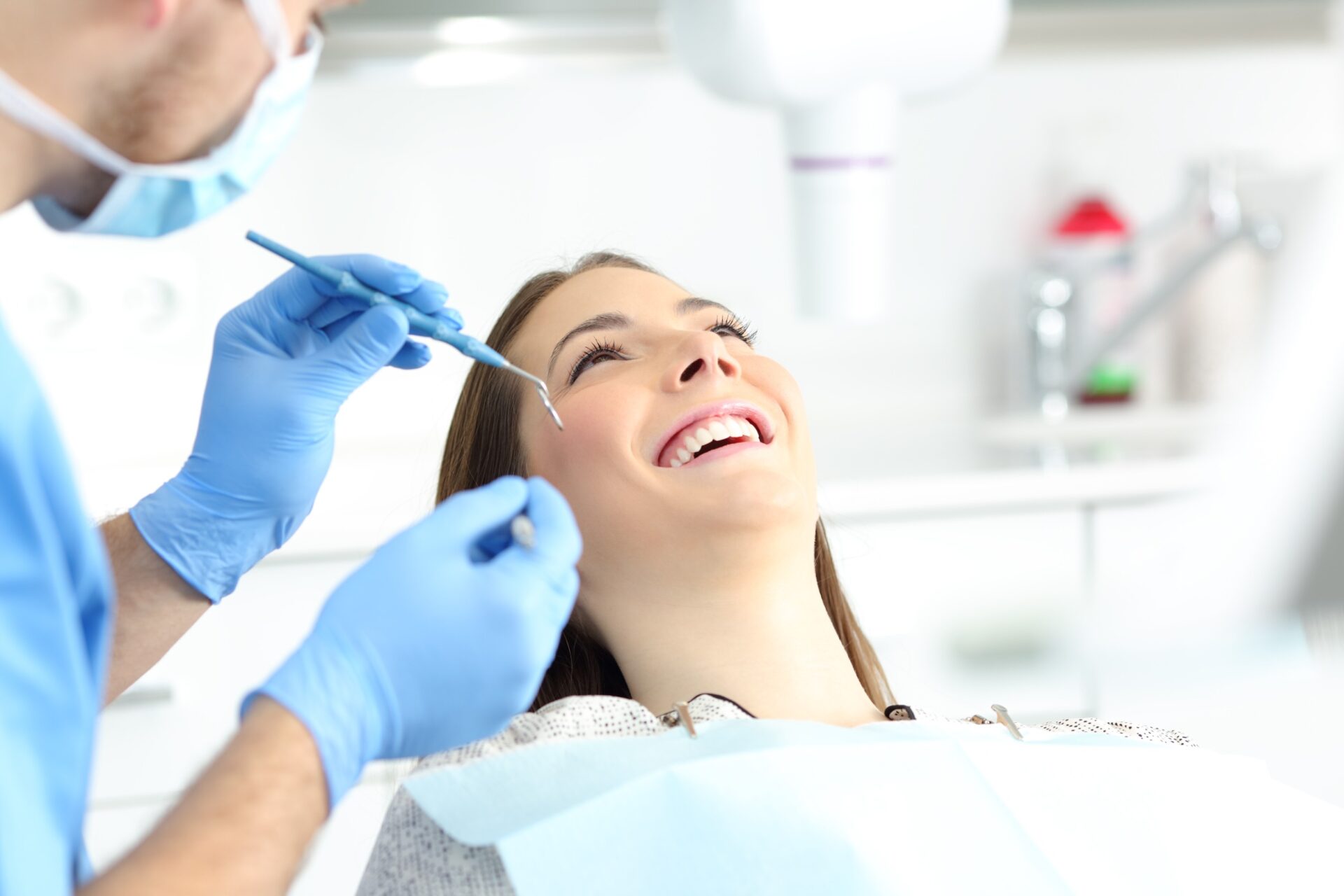 Happy woman with perfect smile in a dentist office ready for treatment