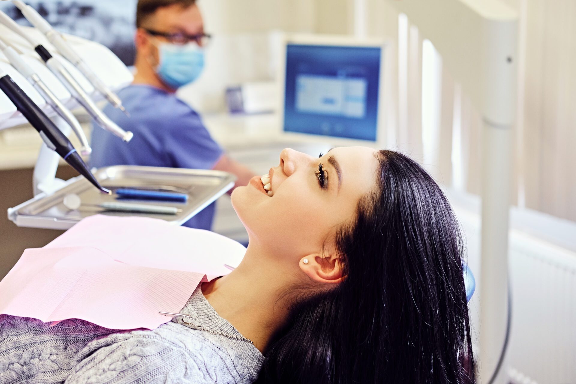 Brunette female on a dentist chair in a stomatology room.